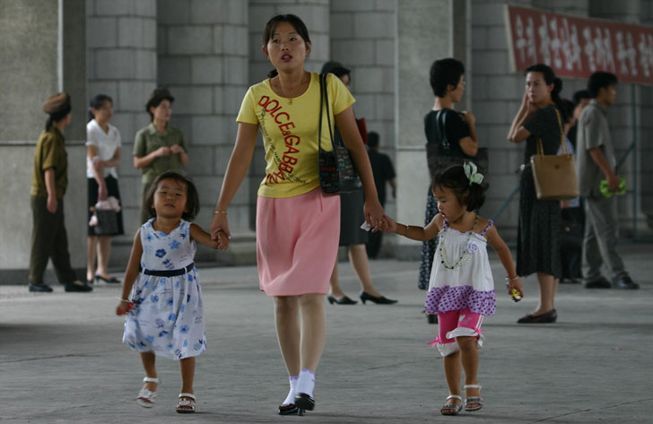   Mother walking with her 2 daughters