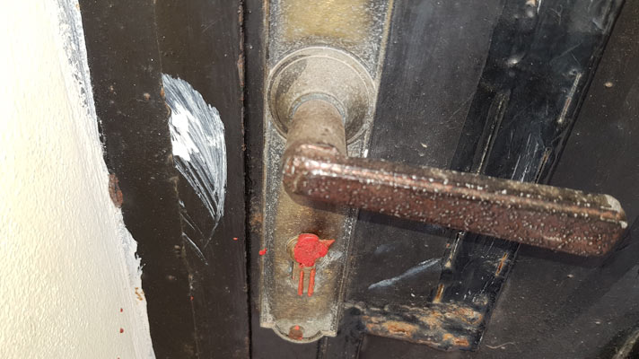 The keyhole of a closed down church sealed with wax