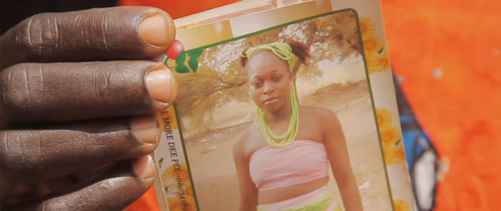 Hannatu holds a photo of her daughter.