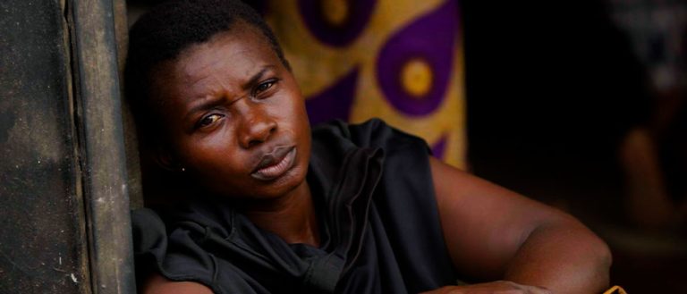 African woman looking at the camera, thoughtful and sad