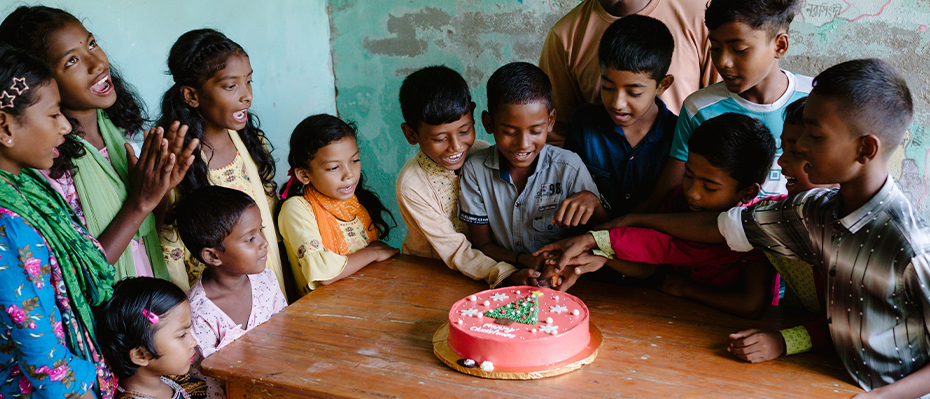 Robin cuts a cake for Christmas.