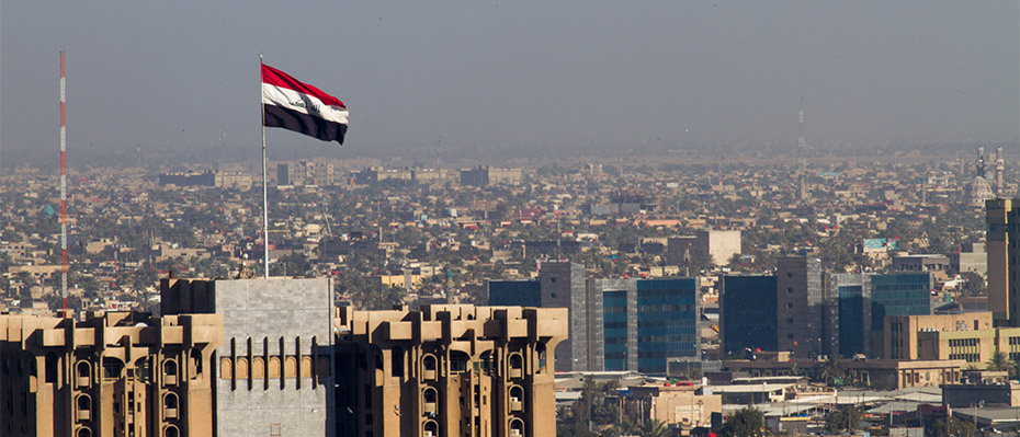 Iranian flag flying over a city backdrop