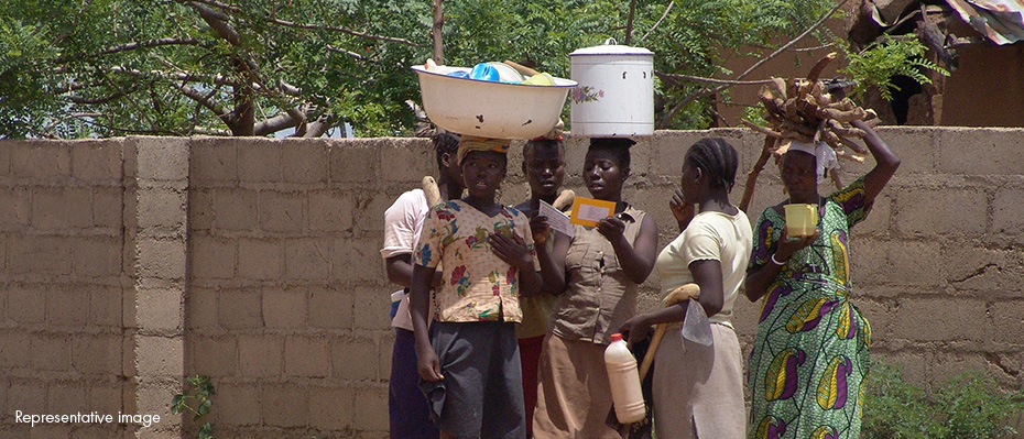 A group of Nigerian woman holding baskets and paper