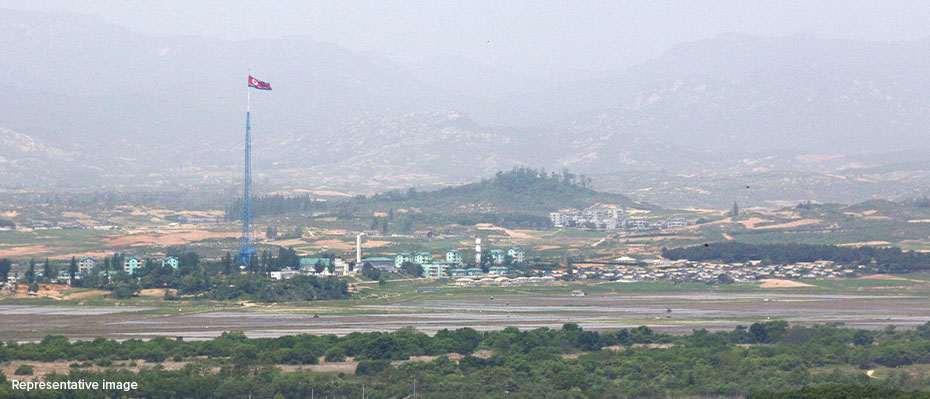 North Korean landscape with flag in foreground