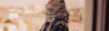 Woman wearing a headscarf and looking at the sky