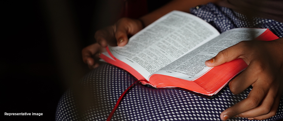 A woman holding a Bible