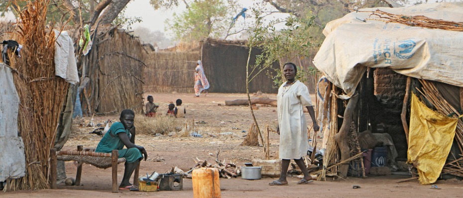 People sat outside makeshift tents