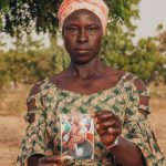 Deborah holding a photo of her late husband Abel
