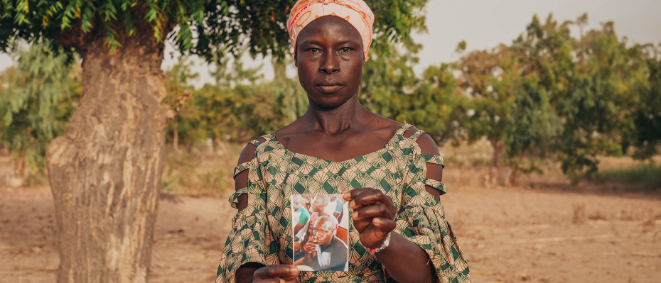 Deborah holding a photo of her late husband Abel
