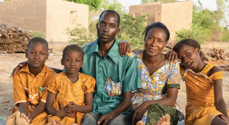 Aicha and her family sit for a family photo.